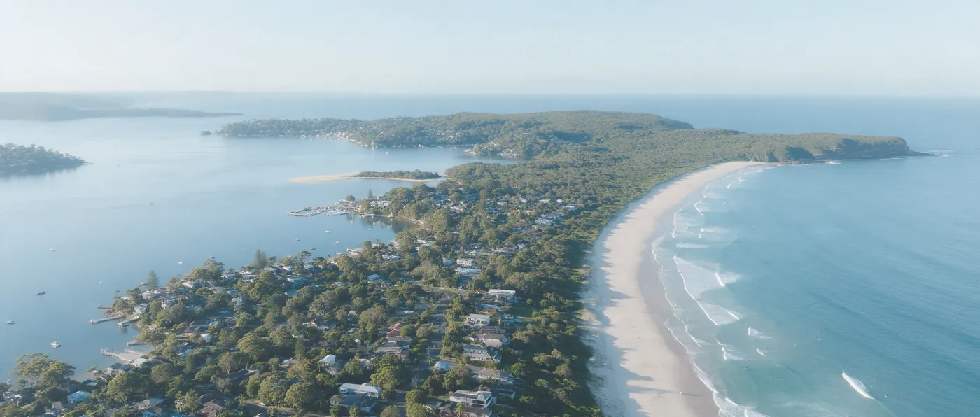 An aerial view of the Northern Beaches with Pittwater on one side and the ocean on the other